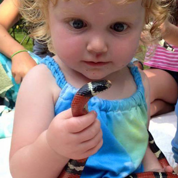 kid holding a snake